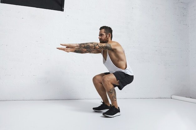 Strong tattooed in white unlabeled tank t-shirt male athlete shows calisthenic moves Squat hold plank exercise
