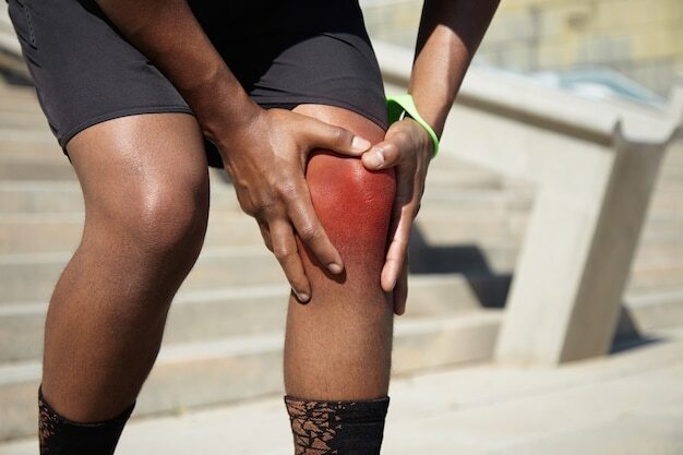 Closeup of young man with knee injury