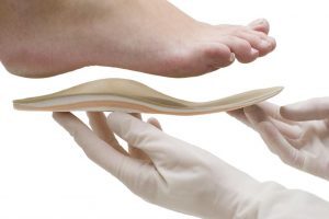 The Best Insoles for Work Boots - a person is holding a pair of foot pads