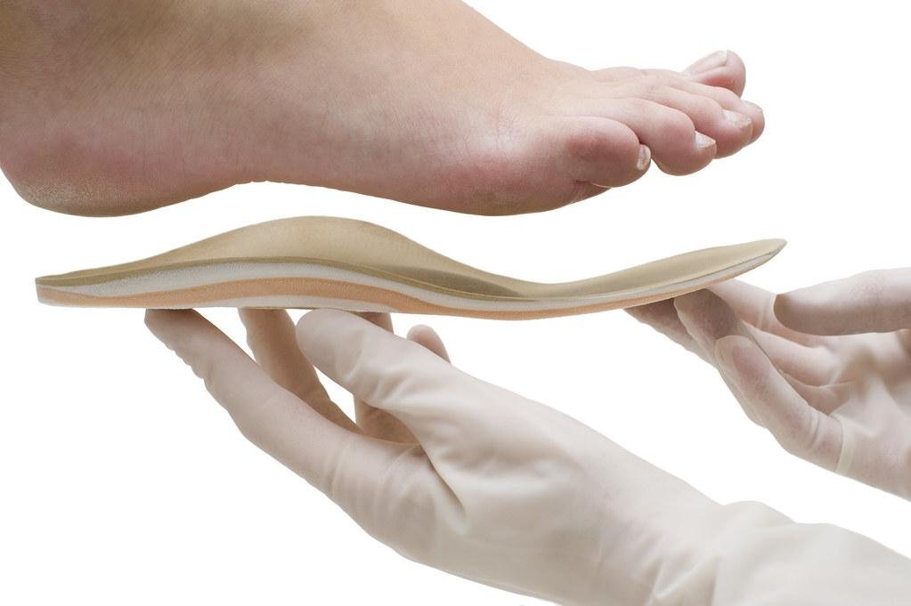 The Best Insoles for Work Boots - a person is holding a pair of foot pads